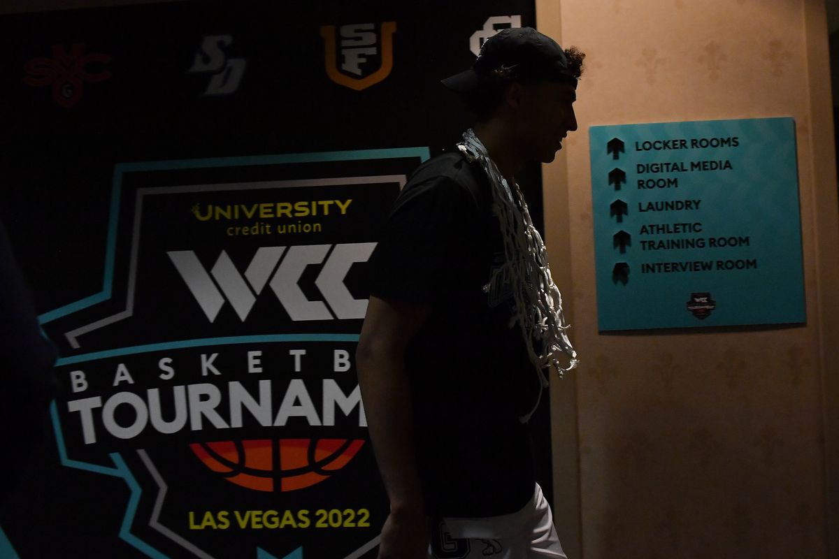 Gonzaga forward Anton Watson sports the game net as a necklace as he walks to the locker room after the Zags defeated Saint Mary