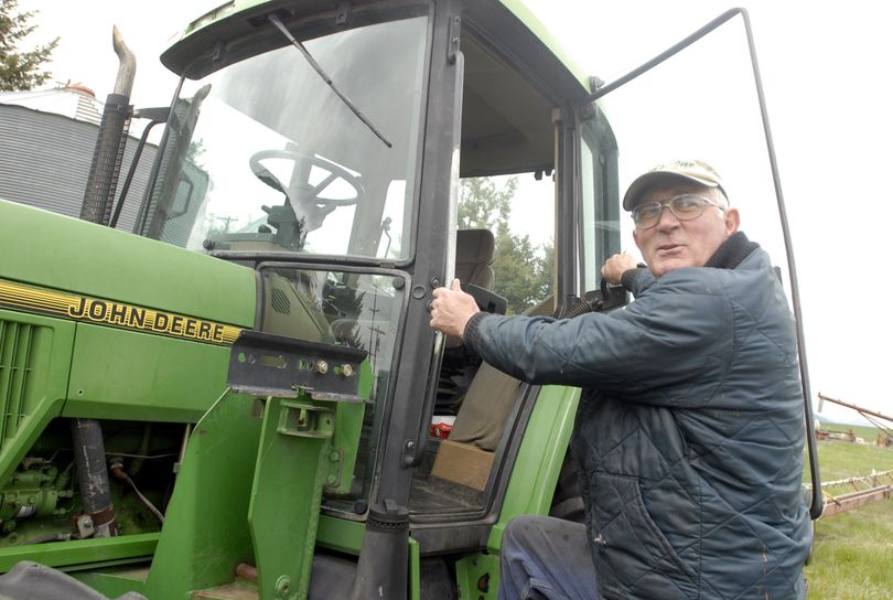 Wayne Meyer, one of the last grass seed farmers on the Rathdrum Prairie and a former state legislator, jokes with family members while clambering into a tractor Friday, May 4, 2007 near Rathdrum.   JESSE TINSLEY The Spokesman-Review (Jesse Tinsley / The Spokesman-Review)