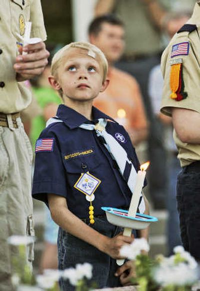 
Baileigh Rohde, 8, holds a candle during a vigil in Omaha, Neb., on Thursday. Associated Press
 (Associated Press / The Spokesman-Review)