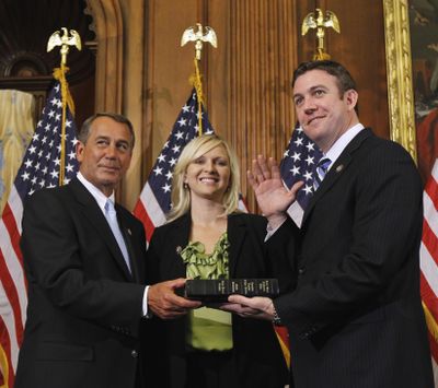 House Speaker John Boehner of Ohio, left, administers the House oath to Rep. Duncan Hunter, R-Calif., as his wife, Margaret, looks on during a mock swearing-in ceremony Jan. 5, 2011, on Capitol Hill in Washington. Hunter and his wife Margaret faced arraignment Thursday, Aug. 23, 2018, in San Diego on charges they illegally used his campaign account for personal expenses. (Alex Brandon / AP)