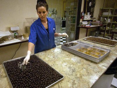 
Andria Hanna boxes up dark chocolate almonds at The Nut Factory in Spokane Valley. The Nut Factory has been in business since 1952 and has grown into a large snack-food manufacturer.
 (File / The Spokesman-Review)