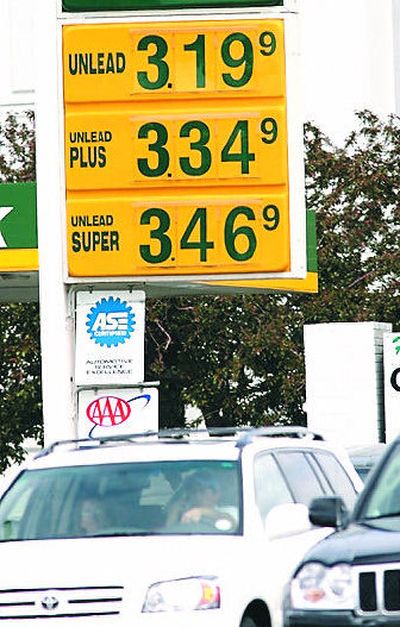 
Traffic passes by a sign listing the prices for different grades of gasoline  at a service station in southeast Denver on Monday. The  national average per-gallon cost of gasoline was $3.035 on  Monday.
 (Associated Press / The Spokesman-Review)