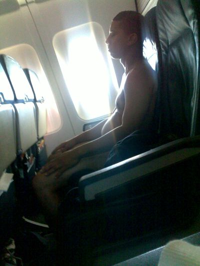 ORG XMIT: LA105 In this photo taken Tuesday, June 30, 2009, Keith Wright, 50, of the Bronx, New York, sits nude on a US Airways flight from Charlotte to Los Angeles after he removed all of his clothing mid-flight. Wright resisted a flight attendant's efforts to cover him with a blanket before two off-duty law enforcement officers on board subdued and handcuffed him. The flight was diverted to Albuquerque where Wright was taken into custody by airport authorities, authorities said. (AP Photo/Marius Langlete) (Marius Langlete / The Spokesman-Review)