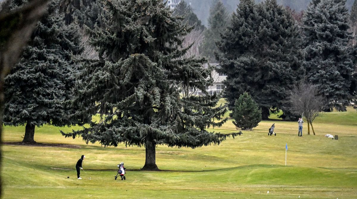 Logan Johnston, left, golfs at Trailhead Golf Course in Liberty Lake while on winter break from Eastern Washington University on Wed, Jan 3, 2024.  (Kathy Plonka/The Spokesman-Review)