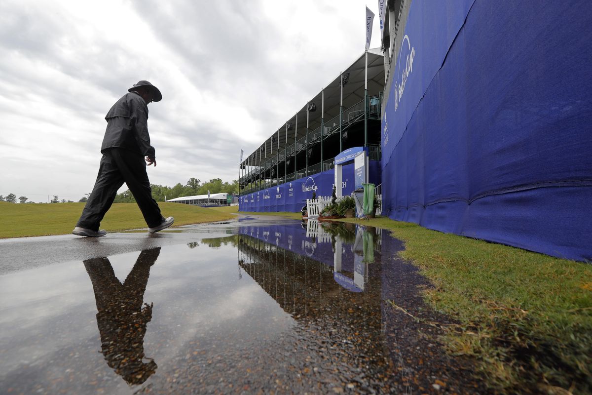 A person walks on the largely empty course during a weather delay for the first round of the PGA Zurich Classic golf tournament at TPC Louisiana in Avondale, La., Thursday, April 25, 2019. (Gerald Herbert / Associated Press)