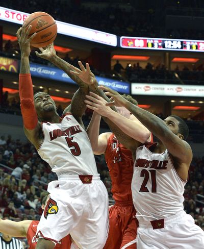 Kevin Ware pulls down a rebound in his first regular-season game since shattering his leg last season. (Associated Press)