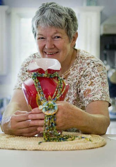 
Bead artist Judy Gilmartin shows off one of her necklace pieces.
 (Photos by Christopher Anderson/ / The Spokesman-Review)
