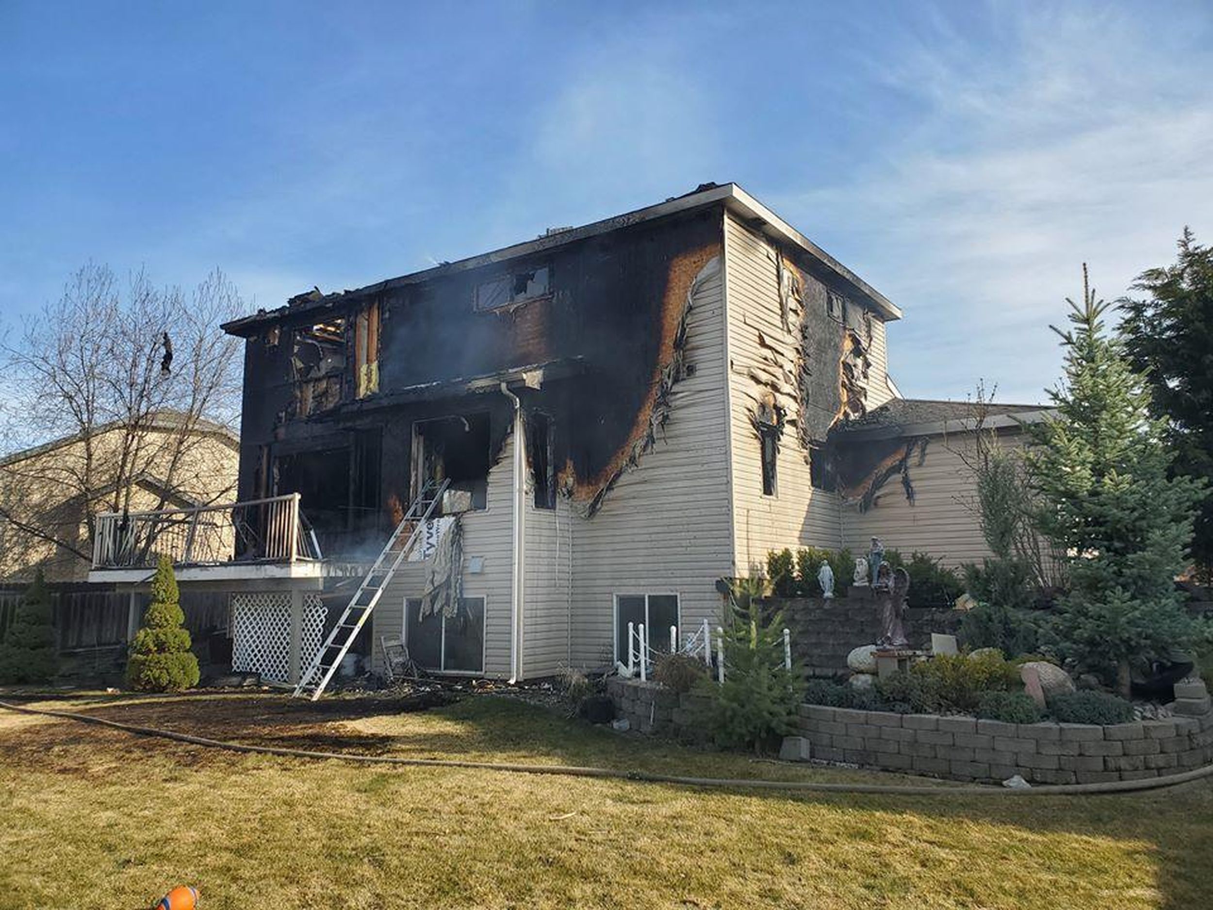 Spokane Valley house fire displaces family of 4, injures firefighter