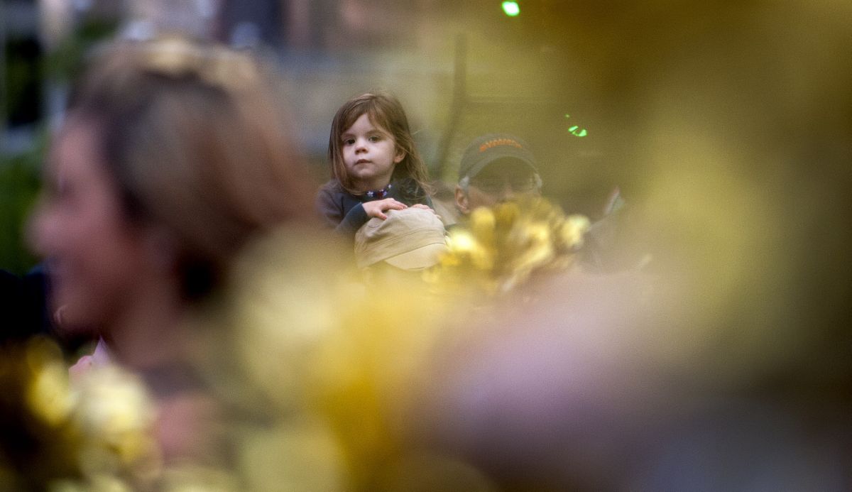 Three-year-old Lilli Dryden, of Spokane, sits on her grandmother’s shoulders to get a better view of the Lilac Festival Armed Forces Torchlight Parade on Saturday night in downtown Spokane. For a list of winners in the float and equestrian competitions, see page A8. (Kathy Plonka)