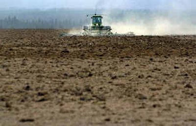 
Even with a few rain showers Wednesday, the fields off U.S. Highway 395 north of Spokane were bone dry. Air quality suffered from blowing dirt. 
 (Jed Conklin / The Spokesman-Review)