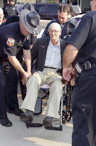 
Police lift Edgar Ray Killen, 80, to the sidewalk in his wheelchair in front of the Neshoba County Courthouse in Philadelphia, Miss., on Monday. 
 (Associated Press / The Spokesman-Review)