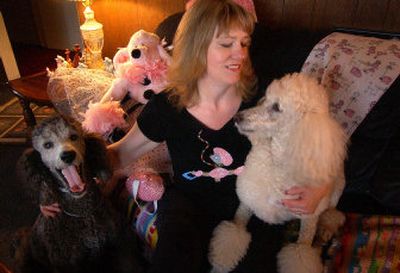 
Tami Richardson hangs out with two of her poodles, Dion, left, and Fancy, in her home recently. Richardson collects anything poodle – from stuffed animals  to T-shirts. 
 (Liz Kishimoto / The Spokesman-Review)