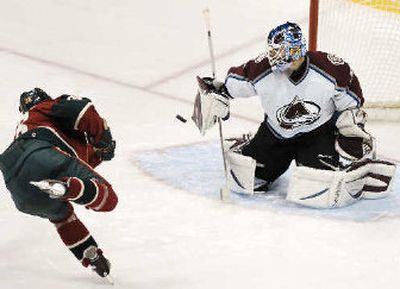 
 Colorado Avalanche goaltender Peter Budaj stops a shot by Minnesota's Pavol Demitra. 
 (Associated Press / The Spokesman-Review)