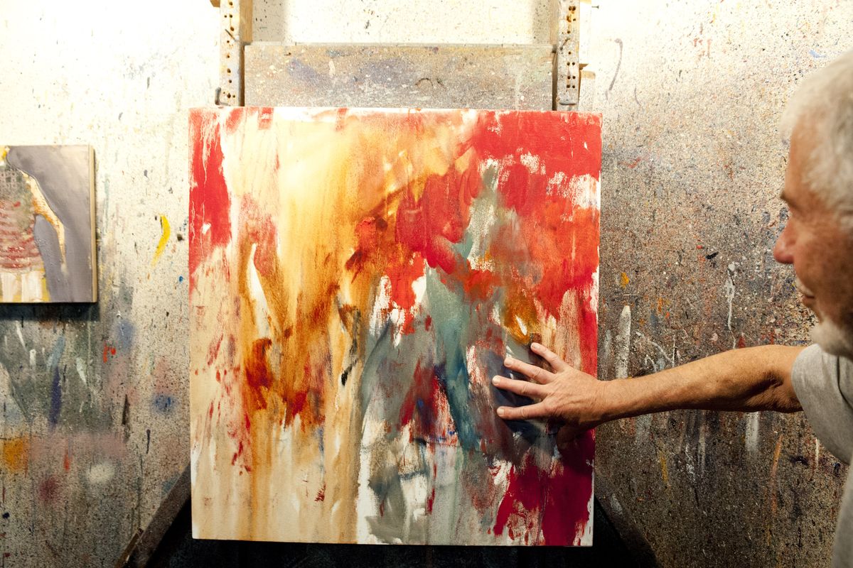 Mel McCuddin runs his hands over a new work in progress at his home studio in Millwood. (Tyler Tjomsland)