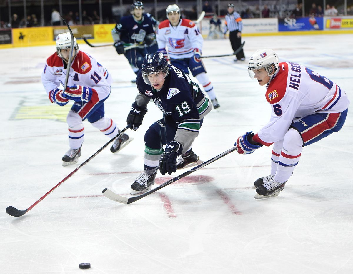 Seattle’s Donovan Neuls (19) moves the puck past the Chiefs’ Liam Stewart (11) and Tyson Helgesen (6) on Sunday. (TYLER TJOMSLAND PHOTOS)