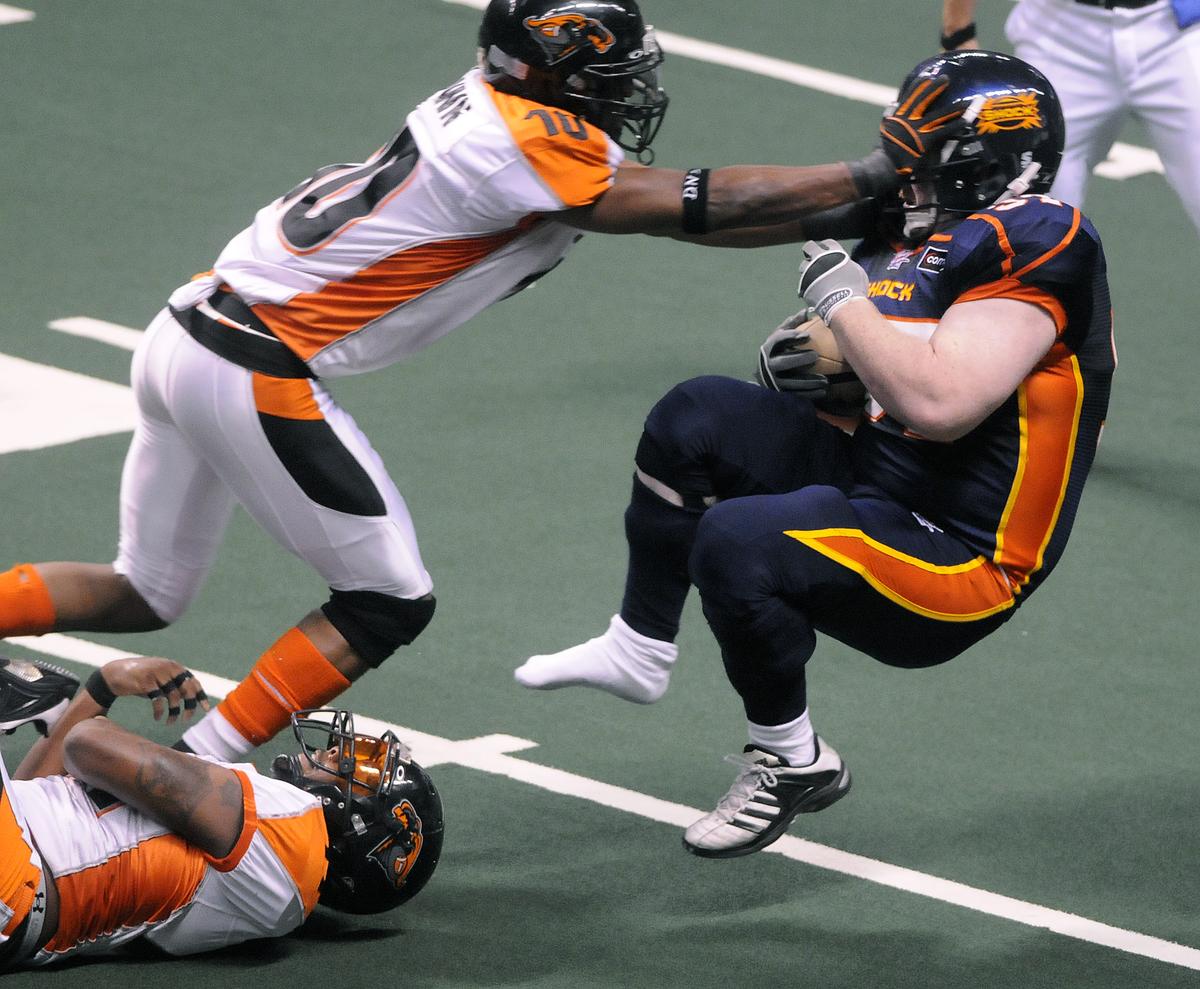 The Spokesman-Review Shoeless Katon Bethay takes a hit from Anthony Brown. (Dan Pelle / The Spokesman-Review)