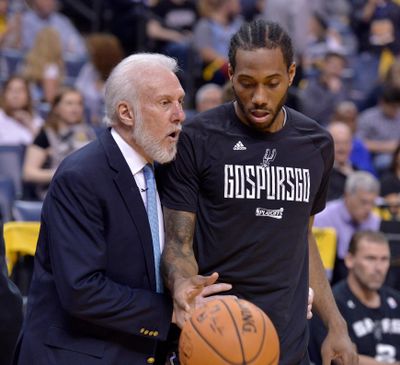 San Antonio Spurs head coach Gregg Popovich, left, talks April 22, 2017, with San Antonio Spurs forward Kawhi Leonard during the second half of Game 4 in an NBA basketball first-round playoff series against the Memphis Grizzlies, in Memphis, Tenn. (Brandon Dill / Associated Press)