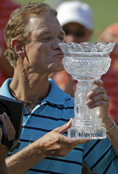 Joe Daley kisses the winner’s trophy on the 18th green after winning the Senior Players Championship at Fox Chapel, Pa. (Associated Press)