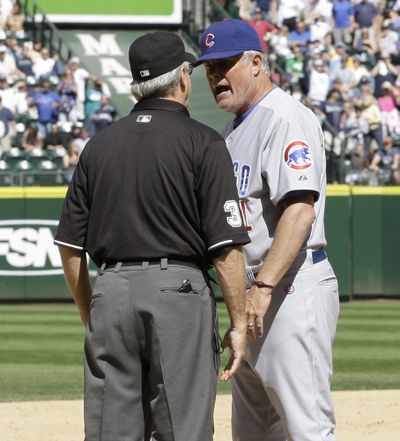 Chicago Cubs manager Lou Piniella, right, argues with third base umpire Mike Reilly during Thursday's game.  (Ted Warren / Associated Press)