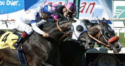 
Lava Man, right, ridden by Corey Nakatani, noses past Ace Blue, ridden by Victor Espinoza, at the finish line.
 (Associated Press / The Spokesman-Review)
