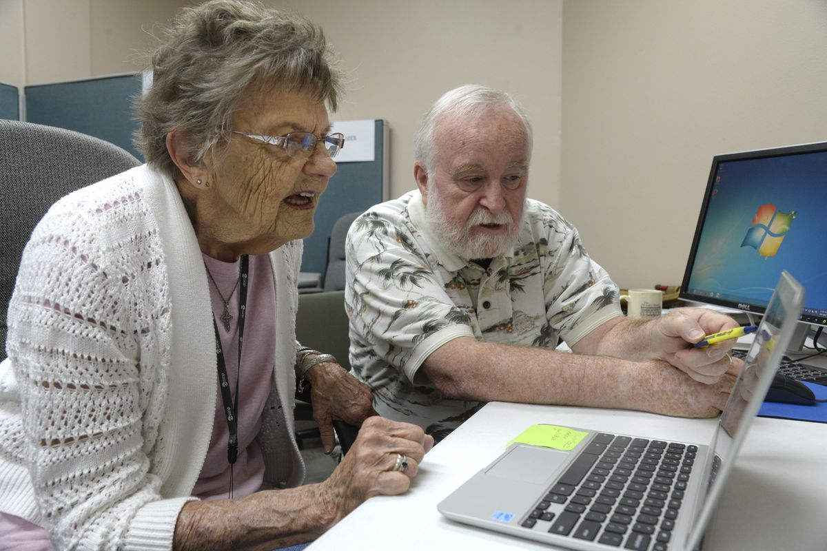 Marion Lysek gets pointers for her new Chromebook computer from Joe Lykins on Tuesday at the Coeur d’Alene Senior Center. (Jesse Tinsley)