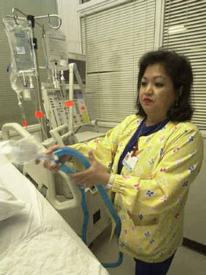 
Lovely R. Suanino, a respiratory therapist at Newark Beth Israel Medical Center in Newark, N.J., demonstrates setting up a ventilator. 
 (Associated Press / The Spokesman-Review)