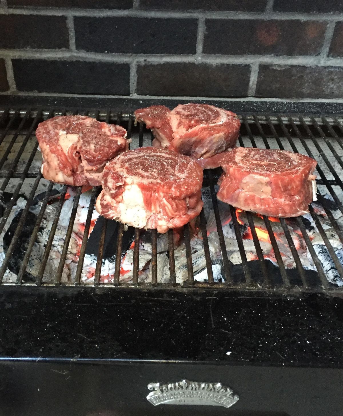 Rib-eye steaks sizzle on Doug Clark’s Feastmaster 400 built-in grill. (Doug Clark / The Spokesman-Review)