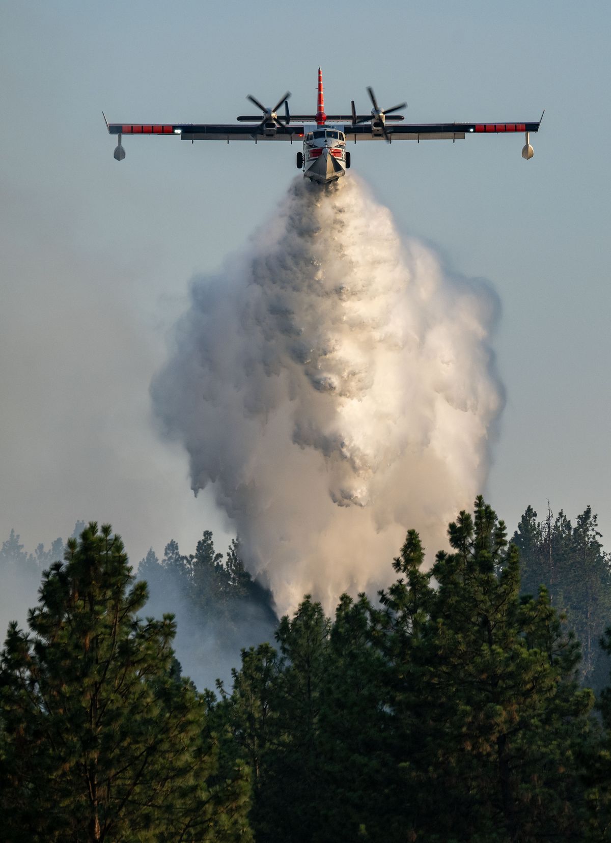 A firefighting aircraft drops a load of water on a wildfire near Palisades Park in west Spokane Friday.  (COLIN MULVANY/THE SPOKESMAN-REVIEW)