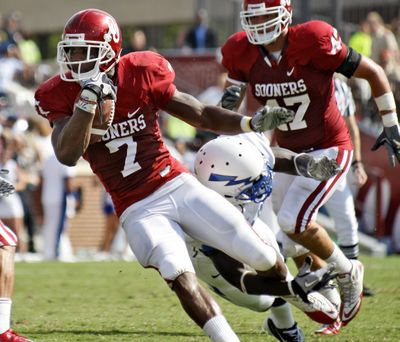 Oklahoma running back DeMarco Murray, left, avoids a tackle by Air Force cornerback Anthony Wright Jr.  (Associated Press)