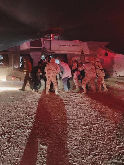 In this photo provided by the Sonora state Health Secretary, children of the extended LeBaron family, who were injured in an ambush are taken aboard a Mexican Airforce helicopter to be flown to the Mexico-U.S. border, from the border between the Mexican states of Chihuahua and Sonora, Monday, Nov.4, 2019. The children were injured when drug cartel gunmen ambushed three SUVs along a dirt road, slaughtering six children and three women, all U.S. citizens living in northern Mexico, in a grisly attack that left one vehicle a burned-out, bullet-riddled hulk. (Sonora state Health Secretary via AP) (AP)