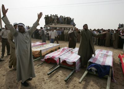 Syrian villagers shout anti-U.S. slogans Monday as they gather near the coffins of relatives who died a day before  in an attack by U.S. military helicopters.  (Associated Press / The Spokesman-Review)