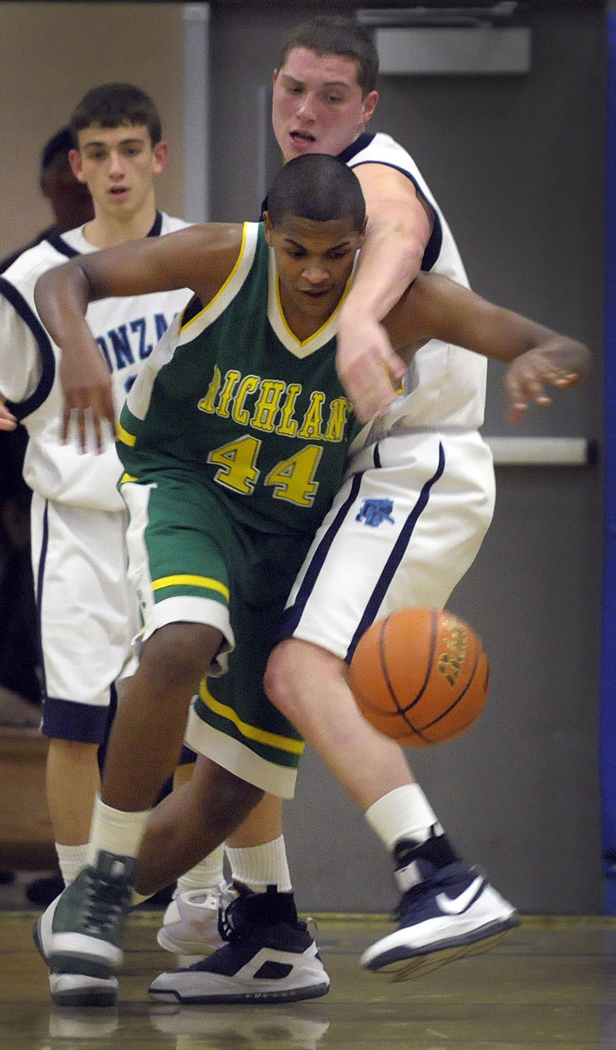 Richland’s Calvin Douglas and Gonzaga Prep’s Travis Long both battle for a loose ball during the Bombers’ win Tuesday. (Christopher Anderson / The Spokesman-Review)