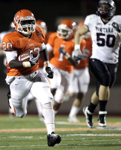 Sam Houston State running back Tim Flanders breaks away from the Montana defense on a touchdown run during the first quarter of Friday’s game. (Associated Press)