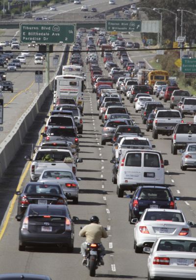 In this photo from 2011, a motorcyclist rides between lanes as traffic backs up on U.S. Highway 101 in Mill Valley, Calif. (Associated Press)