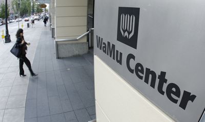 A worker walks into WaMu Center, the headquarters of Washington Mutual Inc., as the workday begins Friday in downtown Seattle. WaMu, one of the nation’s largest banks, was seized by the Federal Deposit Insurance Corp. on Thursday, and then sold to JPMorgan Chase & Co.  (Associated Press / The Spokesman-Review)