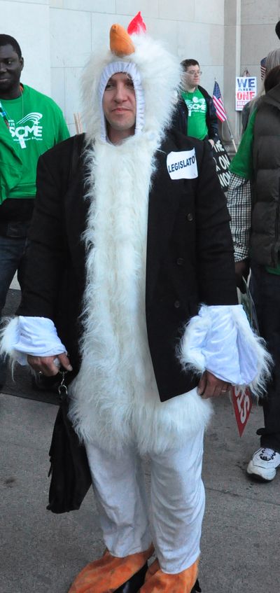 Sean Dannen, Tacoma, an organizer for AFSCME, dresses as what he considers most legislators to be on the issue of closing tax exemptions for businesses. (Jim Camden/The Spokesman-Review)