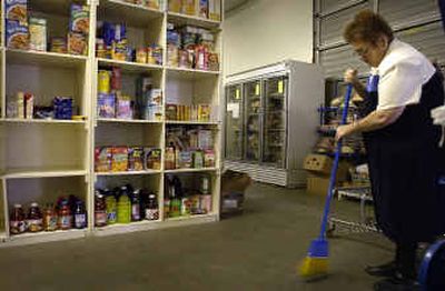 
Post Falls Food Bank manager Cathy Larson, right, cleans up Tuesday afternoon at the food bank, where supplies are running unusually low. 
 (Jesse Tinsley / The Spokesman-Review)