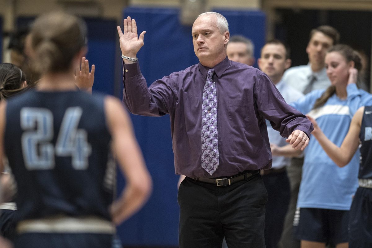 Freddie Rehkow, Central Valley girls basketball coach, high-fives a player in a Dec. 5 game against Mead. (Dan Pelle / The Spokesman-Review)