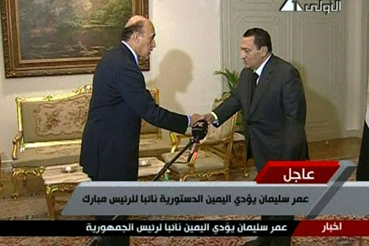In this image  from TV, President Hosni Mubarak, right, shakes the hand of Omar Suleiman, sworn in as vice president, on Saturday.  (Associated Press)