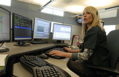 Melanie Thomas works as a 911 call receiver at the Combined Communicaton Center on Monday. Crime check will return  Jan. 5 and Spokane-area citizens will once again have a means to report not-in-progress crimes to local law enforcement agencies.  (J. Bart Rayniak / The Spokesman-Review)