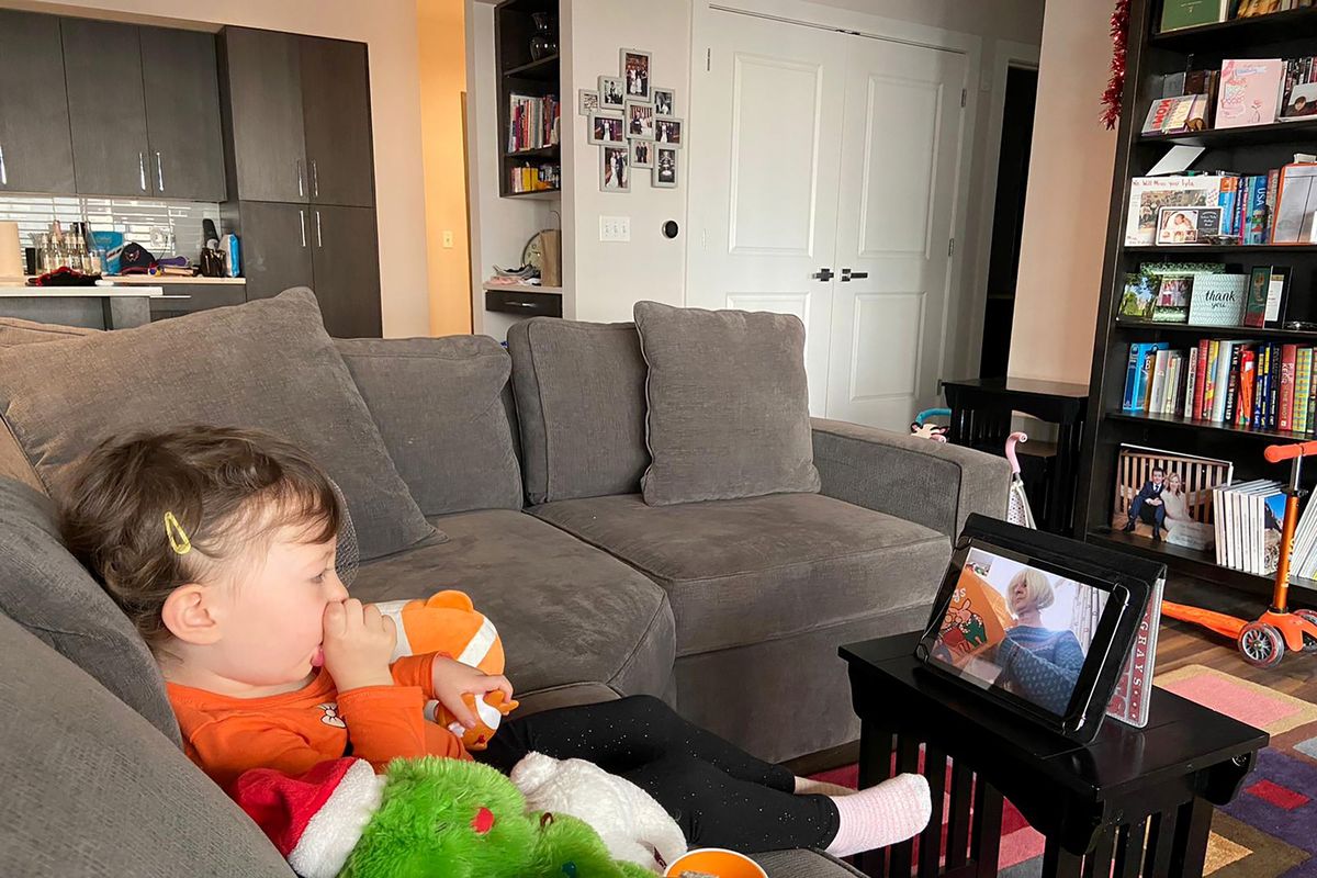 Lyla West of Arlington, Va., watches as her grandmother, Diane West, in Wimbledon, England, reads her a book over FaceTime.  (Family photo)
