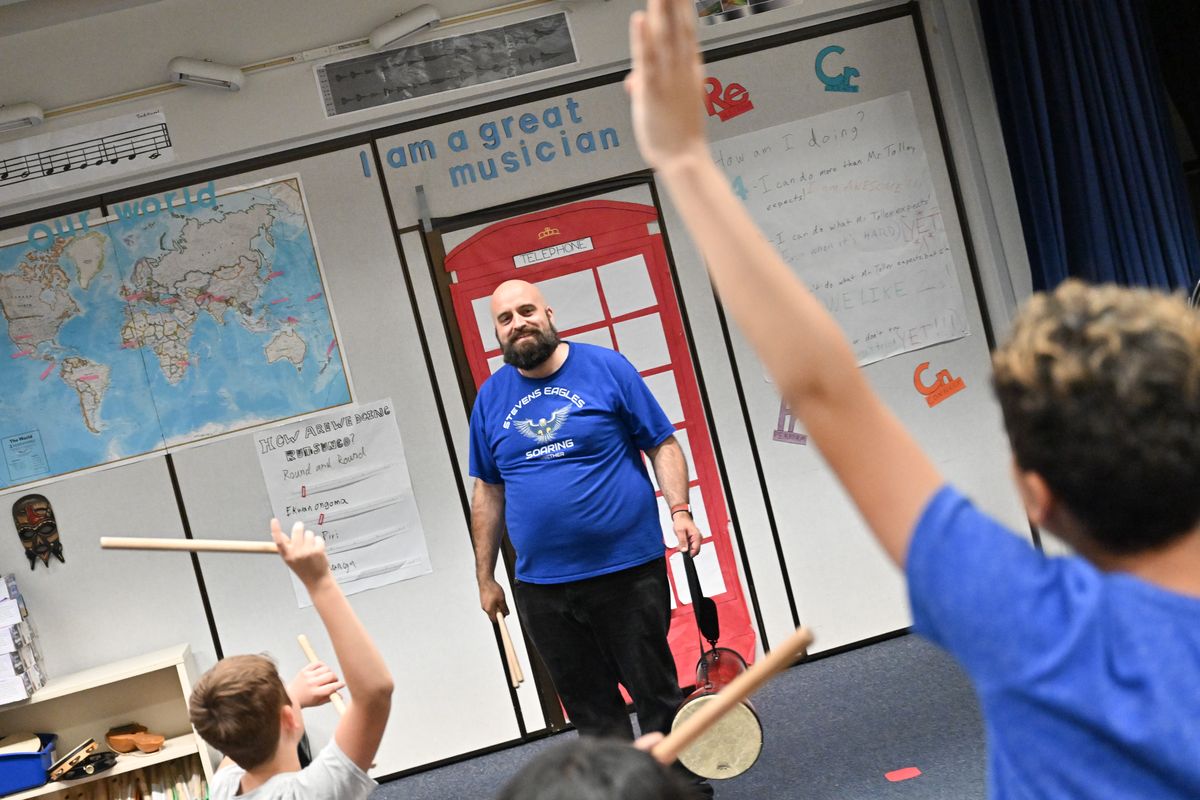 Stevens Elementary music teacher Shawn Tolley smiles as he teaches on Tuesday at Stevens Elementary.  (Tyler Tjomsland/The Spokesman-Review)