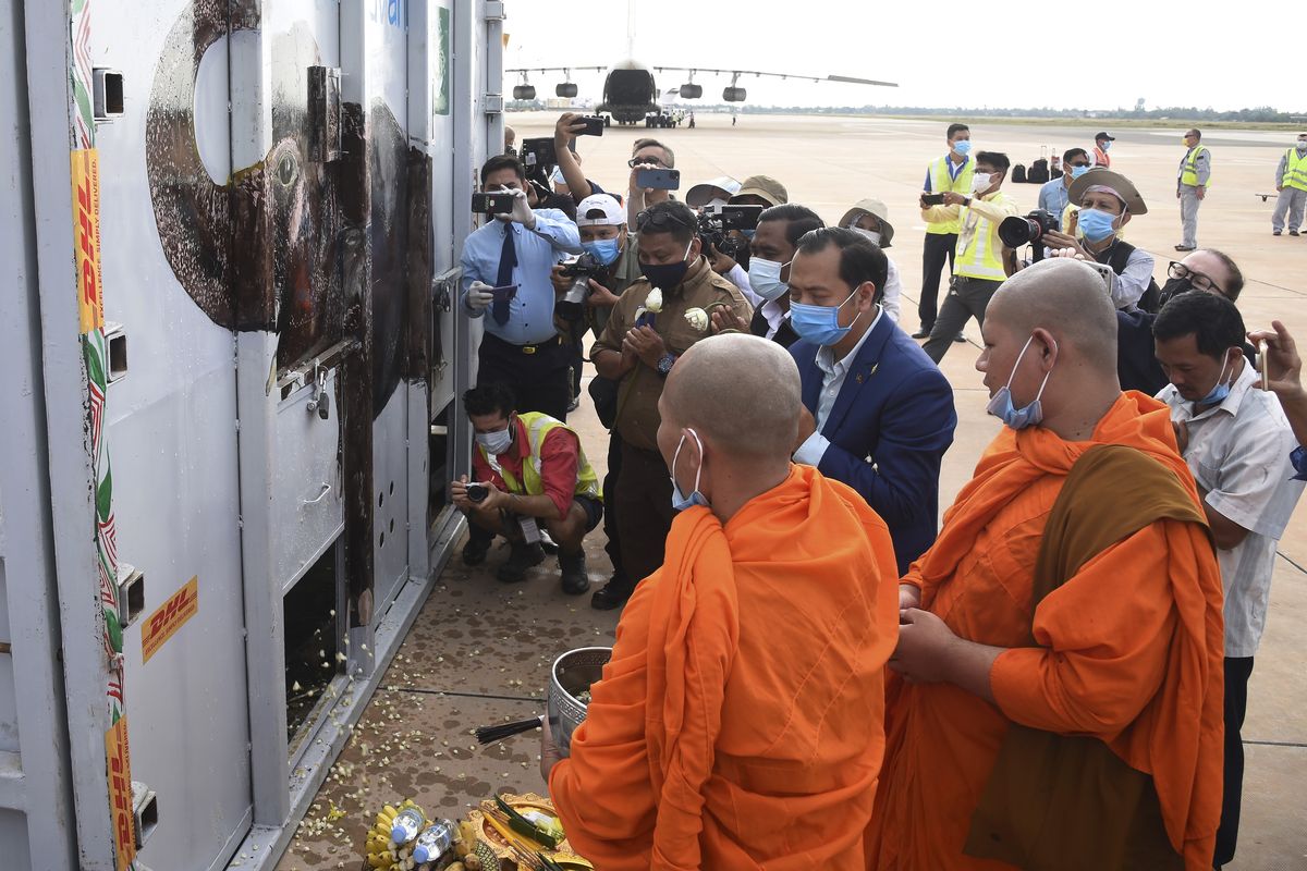 Neth Pheaktra, center, Spokesmen of Environment Ministry, presides over the blessing of a container holding Kaavan the elephant during its arrival from Pakistan at the Siem Reap International Airport, Cambodia, on Monday.  (POOL)
