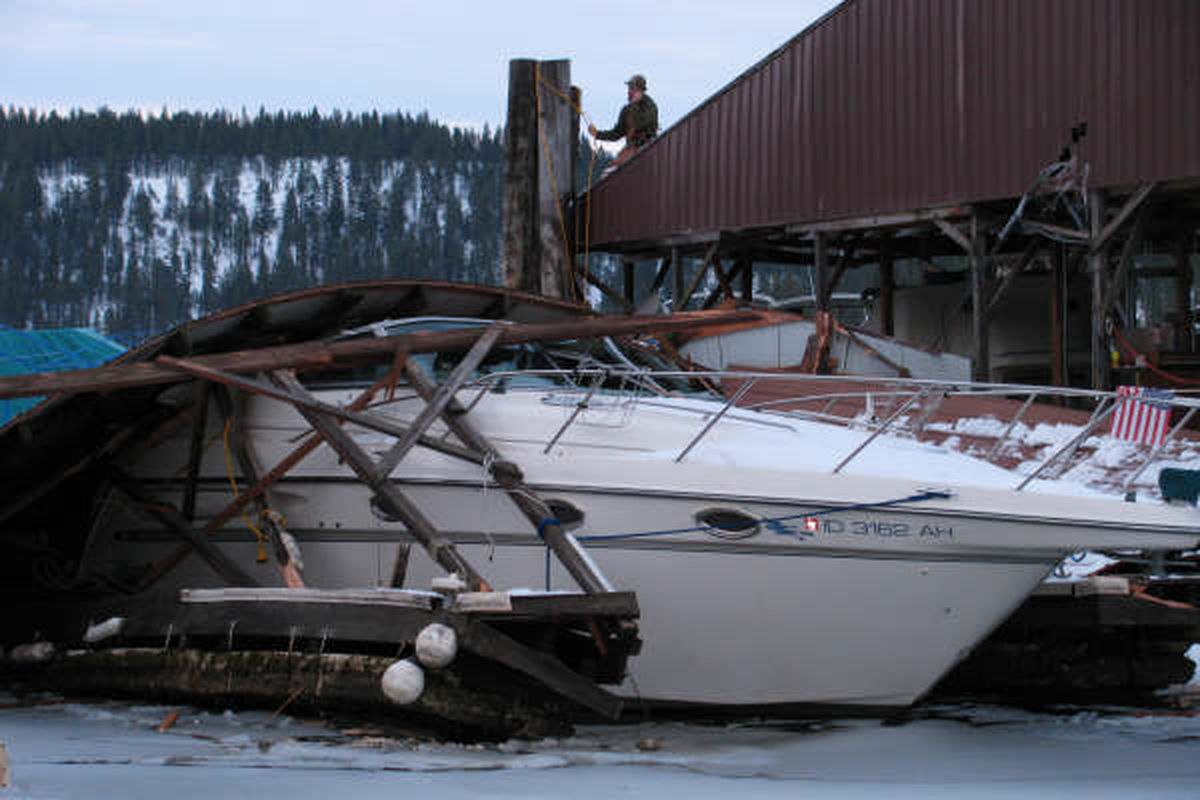 A collapsed portion of roof rests on a damaged boat at a privately owned section of the Conkling Park Marina. Boat owner Mike Gilbert, who took this photo, thinks the roof collapsed late Saturday night, Dec. 27, 2008, under heavy snow. (Courtesy of Mike Gilbert)