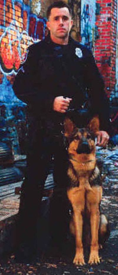 Officer Craig Hamilton is shown with police dog Leonidas on a Spokane Police Department trading card photo.