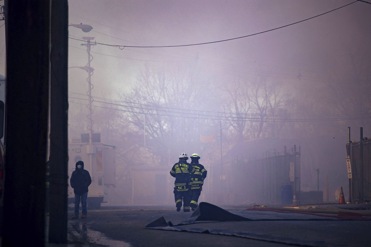 Firefighters battle a blaze in an industrial area on Saturday, Jan. 30, 2021, in Passaic, NJ. The multi-alarm fire in the recycling plant started after midnight and burned into the morning..  (Kevin Hagen)