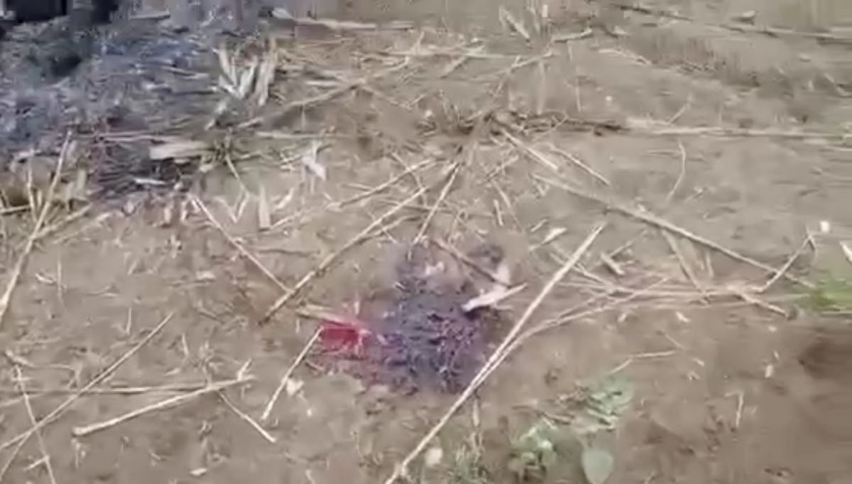 In this image from video taken Dec. 7, 2021, bloodstain is seen on the ground near charred corpses in Done Taw village in the Sagaing region of Myanmar. Outrage spread on social media in Myanmar on Wednesday over images and accounts of the alleged killing and burning of 11 villagers captured by government troops in the country