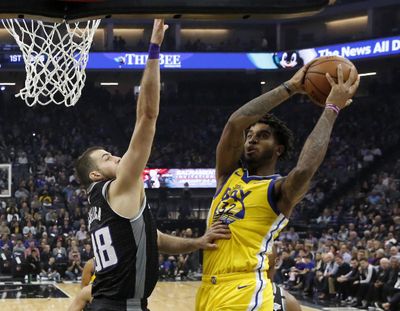 Golden State Warriors forward Marquese Chriss, right, goes to the basket against Sacramento Kings forward Nemanja Bjelica during the first quarter of an NBA basketball game in Sacramento, Calif., Monday, Jan. 6, 2020. (Rich Pedroncelli / Associated Press)