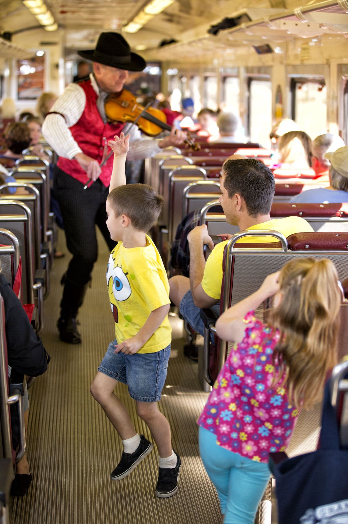 A performer plays violin onboard the railway train on its daily run between Williams, Ariz., and the Grand Canyon’s South Rim. (Associated Press)