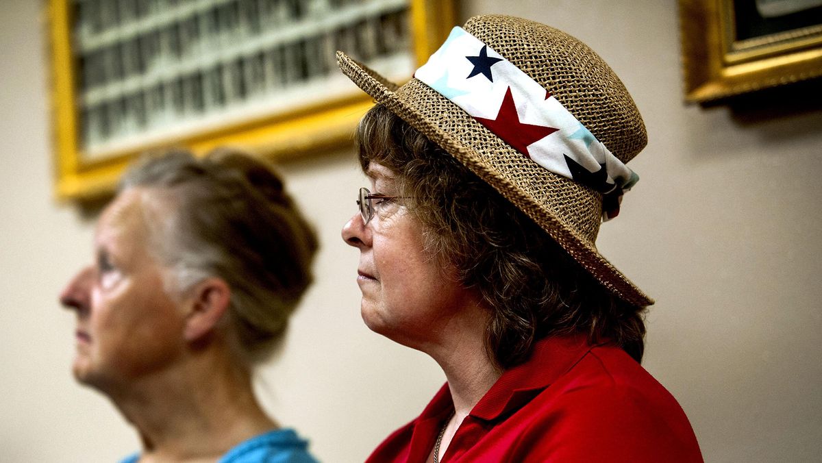 Mullan, Idaho, resident Ninette Reitz, front, of the Shoshone County Republicans listens to Idaho  Rep. Raul Labrador during a visit to Wallace on July 27. (Kathy Plonka / The Spokesman-Review)